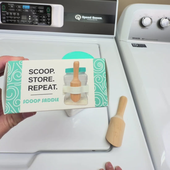 Video demonstration showing how The Scoop Saddle clips onto Buff City Soap laundry detergent jars to securely hold wooden scoops, creating an organized, Pinterest-style laundry shelf